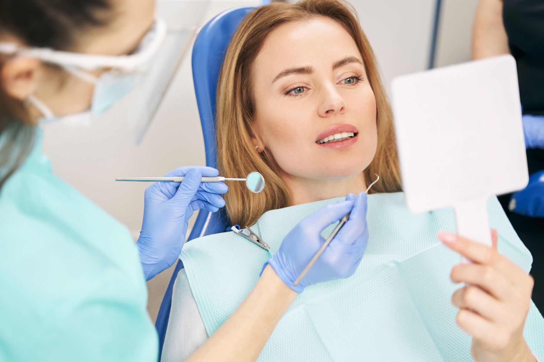 Woman has dental cleaning at dentist