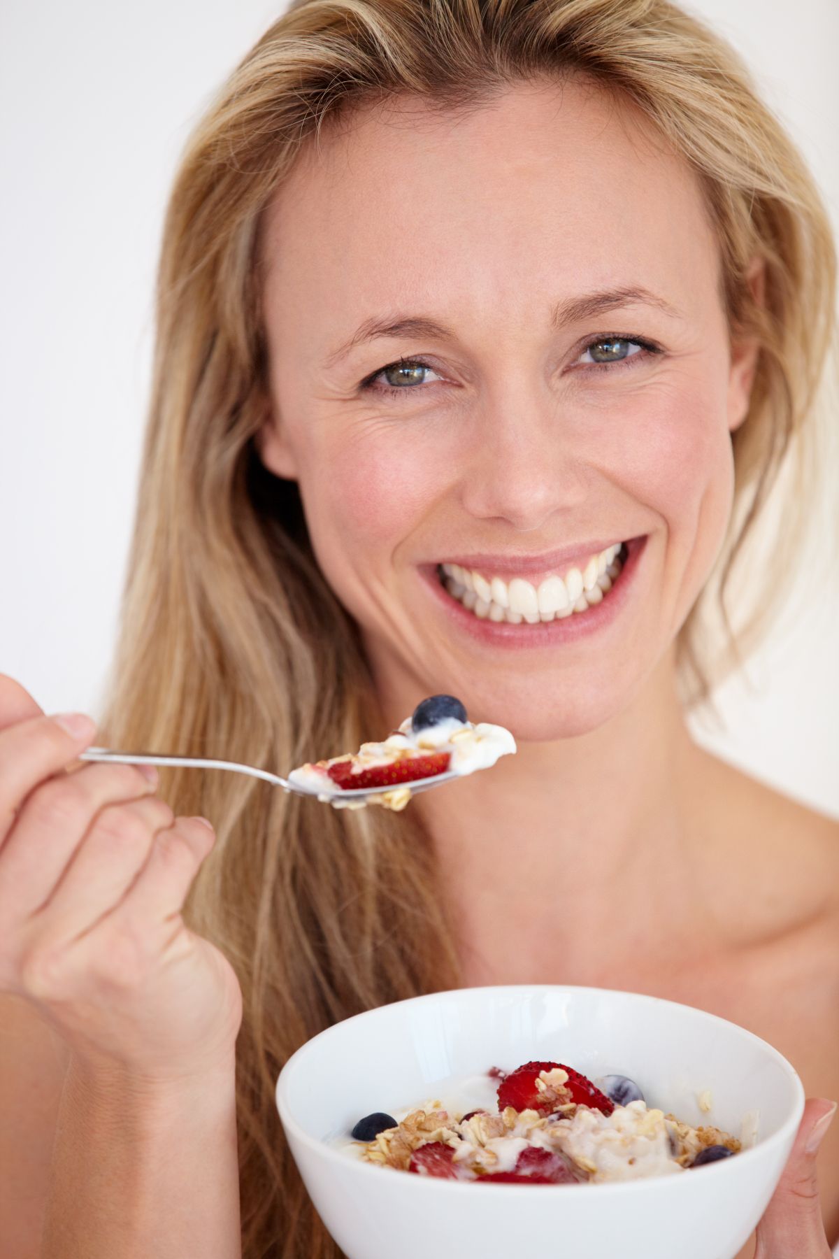 Woman with white teath eating healthy